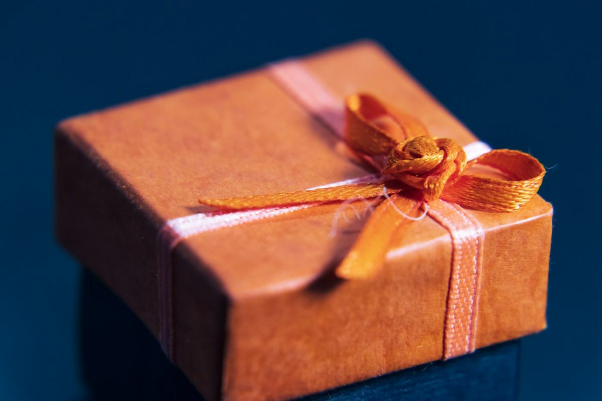 An orange gift box tied with a ribbon