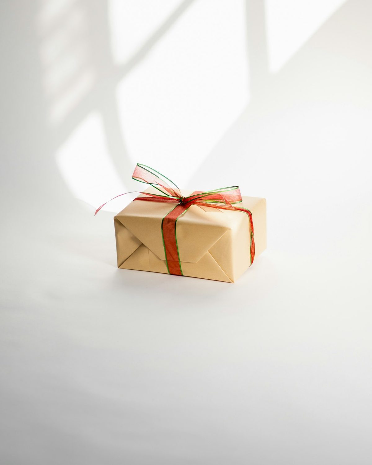 A small kraft gift tied with a ribbon on a white background