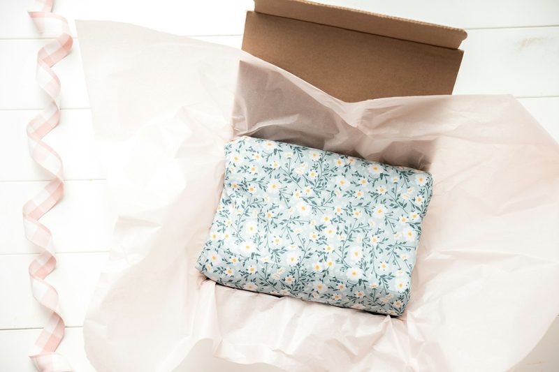 A gift box packed with fabric and tissue paper