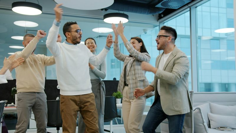 Colleagues celebrating in a modern open-plan office